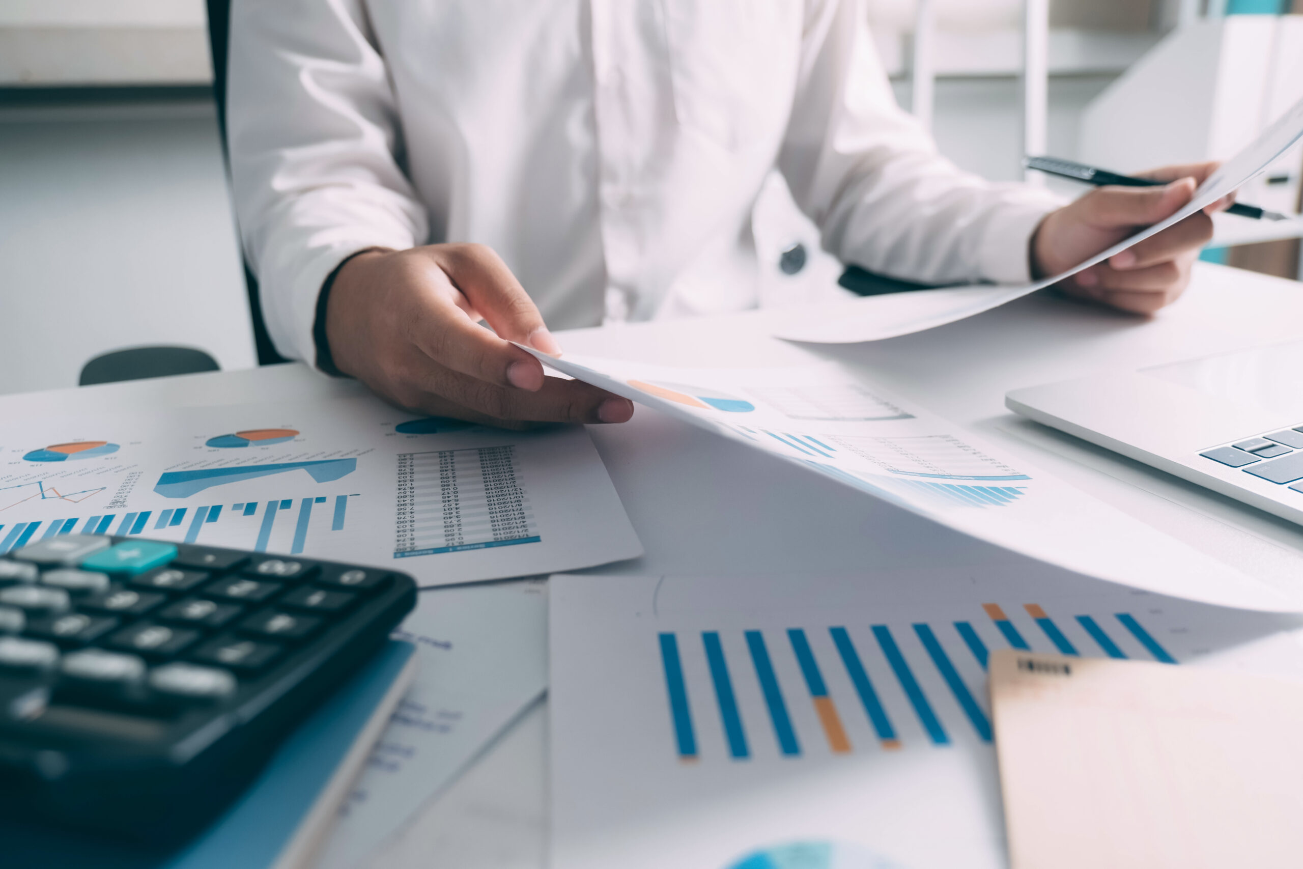 Businessman is thinking and analyse planing the strategy. Businessman working financial Manager Researching Process accounting calculate analyse market graph data stock information review on the table in office.